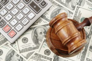 a gavel with money and a calculator